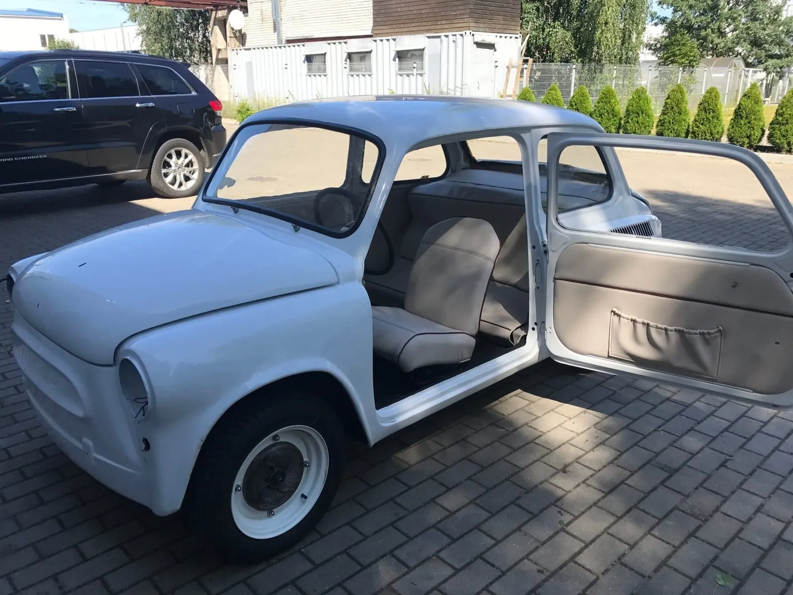 The white electric ZAZ 965 with its doors open