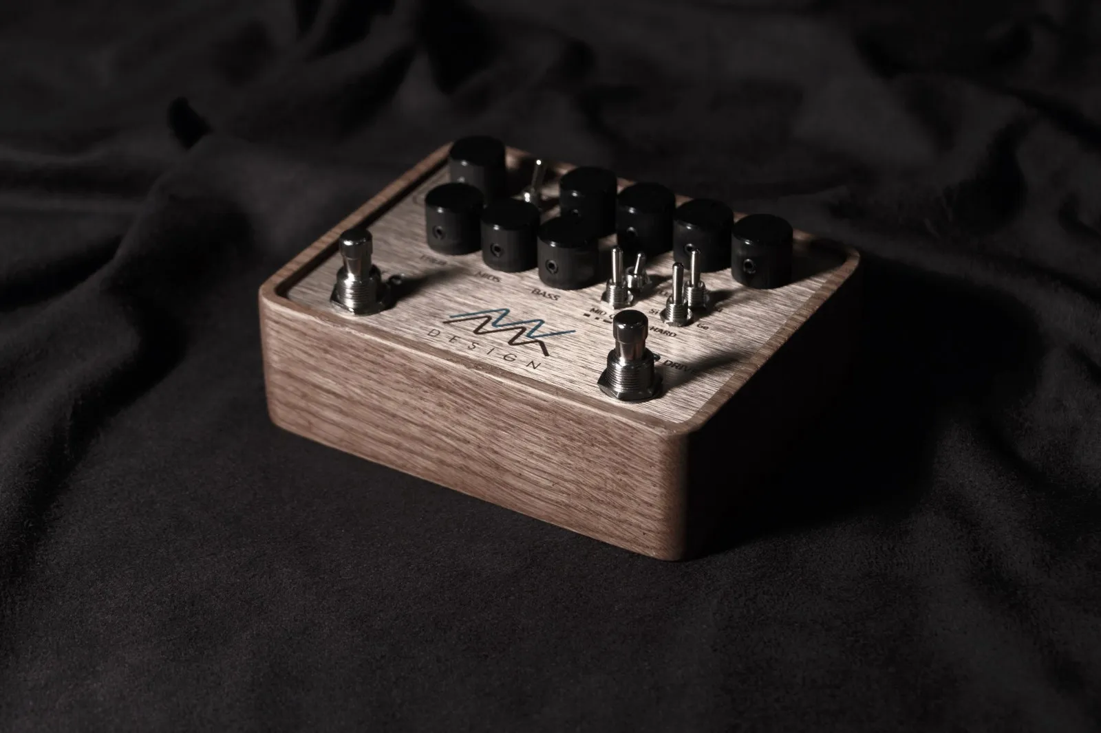 MK Design guitar pedal in an oak enclosure with black knobs